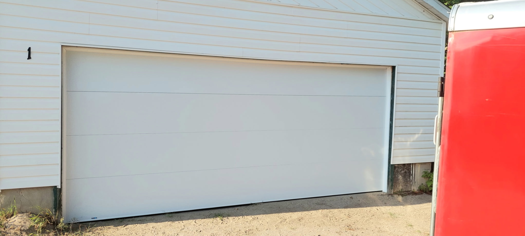 White flush garage door residential installation by T&J Overhead Doors