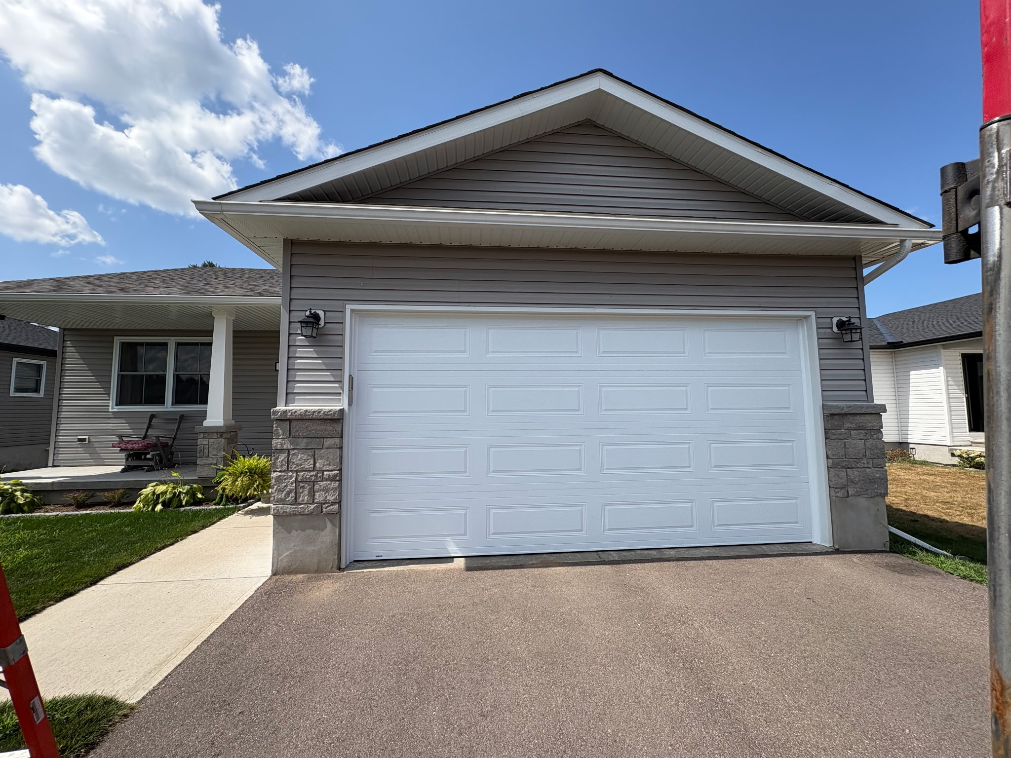 White raised panel garage door on home by T&J Overhead Doors